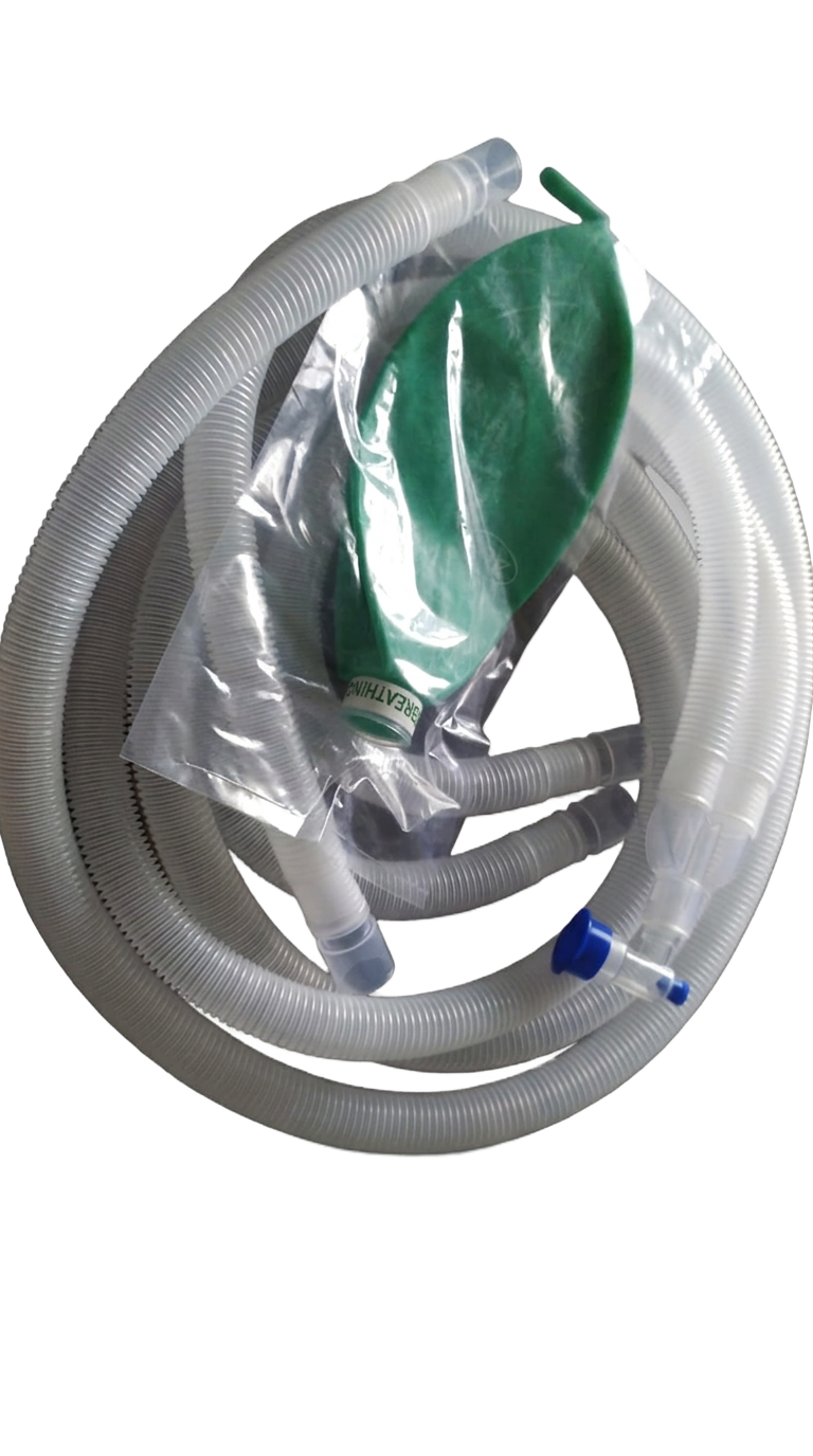 Anaesthetic breathing circuit coiled with a green breathing bag